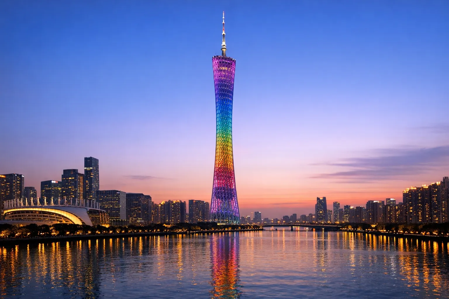 The slender Canton Tower lit above the Pearl River in Guangzhou.